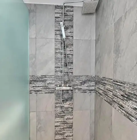 1 Bedroom Condo for Rent at Sands Condominium bathroom with rainfall showerhead and mosaic tile accent