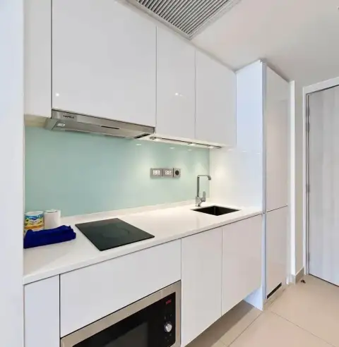 1 Bedroom Condo for Rent at Sands Condominium white modern kitchen with built-in stove and sink
