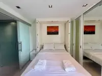 Studio Condo for Sale at Sands Condominium bed with folded towels and glass sliding door to bathroom