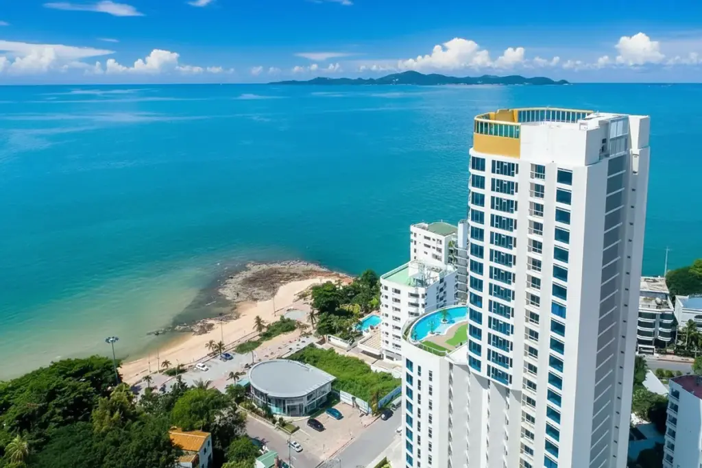Sands Condominium aerial view of the tall white building overlooking the blue ocean and coastline in Pattaya.