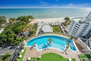 Sands Condominium rooftop infinity pool with palm trees, wooden deck, and stunning ocean views.
