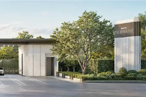 Patta Terrane branded entrance pillar with guardhouse, lush green trees, and manicured hedges along the roadside