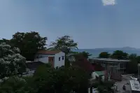 1 Bedroom Condo for Sale at Sea Sky By Sand sea view from hillside surrounded by lush greenery and nearby villas in Pattaya