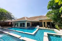 4 Bedroom House for Sale & Rent at Sedona Villas 1 exterior view with tiled roof, pool, and tropical garden