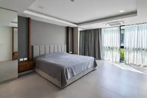 2 Bedroom Condo for Rent at Serenity Residence Jomtien master bedroom with king bed and sheer curtains