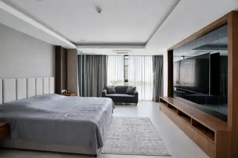 2 Bedroom Condo for Rent at Serenity Residence Jomtien bedroom with seating area and built-in TV unit