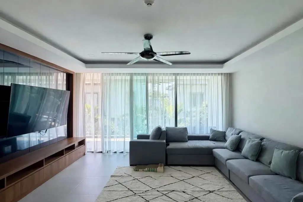 2 Bedroom Condo for Rent at Serenity Residence Jomtien living room with gray sectional sofa and ceiling fan