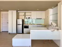 2 Bedroom Condo for Sale at Seven Seas Condo Resort open-plan kitchen with light wood cabinets and built-in fridge