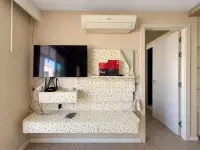 2 Bedroom Condo for Sale at Seven Seas Condo Resort living area with wall-mounted TV and air conditioning unit