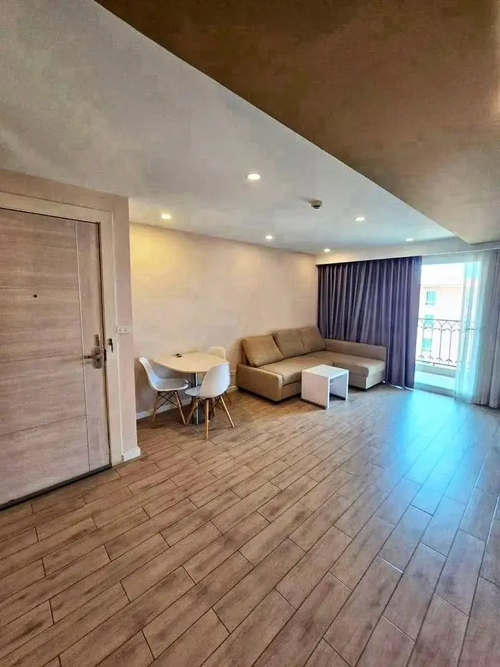 1 Bedroom Condo for Sale at Seven Seas Condo Resort living room with sofa, dining table, and balcony access