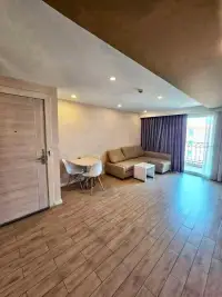 1 Bedroom Condo for Sale at Seven Seas Condo Resort living room with sofa, dining table, and balcony access