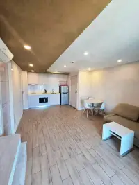 1 Bedroom Condo for Sale at Seven Seas Condo Resort open-plan living area with kitchenette and wood flooring