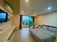 1 Bedroom Condo for Rent at Seven Seas Condo Resort bedroom with king bed, balcony and wall-mounted TV