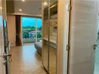 1 Bedroom Condo for Rent at Seven Seas Condo Resort hallway with mirrored wardrobe and view of bedroom