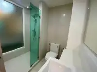 1 Bedroom Condo for Rent at Seven Seas Condo Resort bathroom with glass-enclosed rain shower and toilet