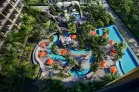 2 Bedroom Condo for Sale at Grand Solaire Noble bedroom with wall-mounted TV and Pattaya skyline view