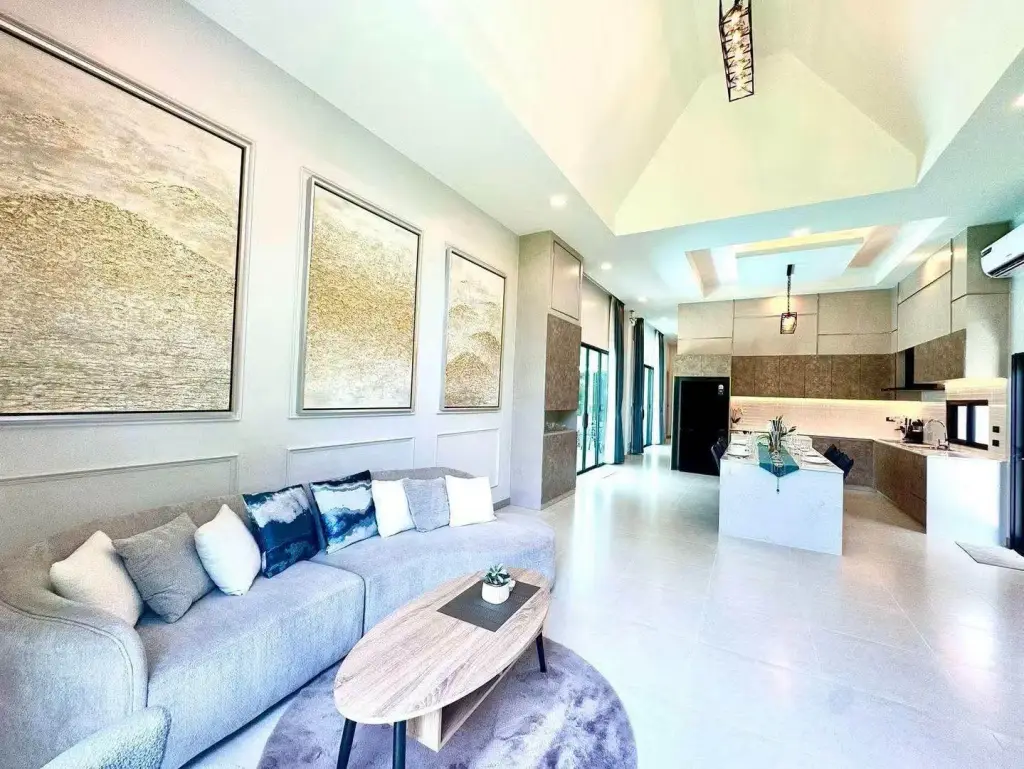 3 Bedroom House for Sale & Rent in Mabprachan open-plan living room with gray sofa and kitchen view