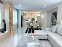 4 Bedroom House for Sale in Mabprachan open-plan living room with gray sofa and dining area