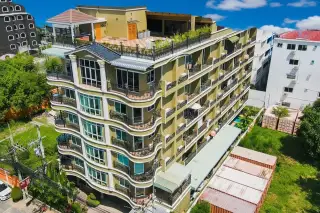 Siam Oriental Condominium aerial view of the multi-story building with curved balconies and a rooftop terrace.