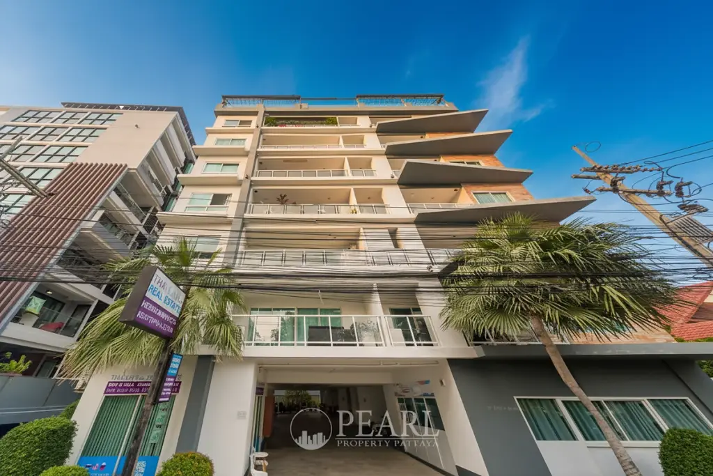 Siam Oriental Elegance 2 modern condo building exterior with balconies, palm trees, and street view.
