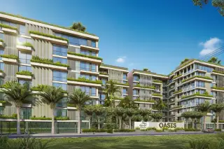 Siam Oriental Oasis modern condo buildings with extensive green landscaping, palm trees, and the property sign at the entrance.