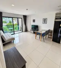 2 Bedroom Condo for Rent at Siam Oriental Plaza open-plan living room with dining table, sofa, and balcony access