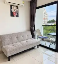 2 Bedroom Condo for Rent at Siam Oriental Plaza living area with sofa bed, balcony seating, and city view