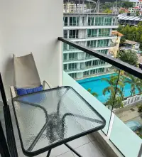 2 Bedroom Condo for Rent at Siam Oriental Plaza private balcony with chair, table, and pool view