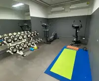 1 Bedroom Condo for Sale at Siam Oriental Tropical Garden fitness room with dumbbells and exercise equipment