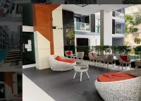 1 Bedroom Condo for Sale at Siam Oriental Tropical Garden lobby lounge area with rattan chairs and red cushions