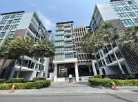 1 Bedroom Condo for Sale at Siam Oriental Tropical Garden exterior building facade with palm trees and entrance