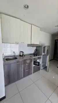 1 Bedroom Condo for Sale at Siam Oriental Tropical Garden kitchen with granite countertop and fridge