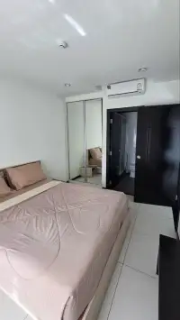 1 Bedroom Condo for Sale at Siam Oriental Tropical Garden bedroom with mirrored closet and ensuite bathroom door