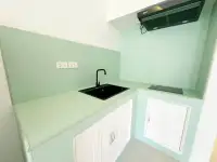 2 Bedroom Condo for Sale at Siam Penthouse 3 compact kitchenette with black sink, faucet and mint green countertops