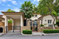 3 Bedroom House for Sale at Silk Road Place exterior facade with covered carport, stone wall and gated entrance