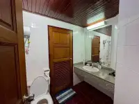 1 Bedroom Condo for Sale at Sky Beach bathroom with wooden door, granite vanity and tiled flooring