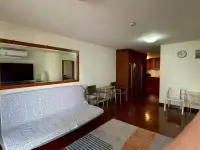1 Bedroom Condo for Sale at Sky Beach living room with patterned sofa, wooden flooring and open kitchen view