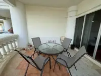 1 Bedroom Condo for Sale at Sky Beach private balcony with table, chairs and classic balustrade railing