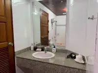 1 Bedroom Condo for Sale at Sky Beach bathroom vanity with mirror, sink and bathtub reflection