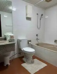 Studio Condo for Sale at Sky Beach bathroom with soaking tub, toilet, and granite vanity