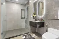 2 Bedroom Grand Executive Condo for Sale at Aquarous Jomtien Pattaya: Modern bathroom with glass shower, floating vanity, and illuminated mirror.