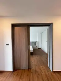 2 Bedroom Condo for Rent at Stasia Dormy Residence sliding wooden door leading into bedroom with wardrobe
