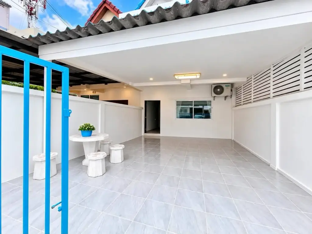 2 Bedroom Townhouse for Rent at Suksabai Villa covered carport with blue gate and tiled flooring