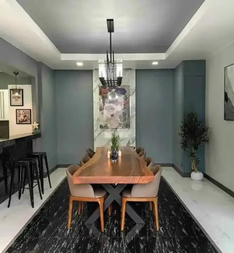 5 Bedroom House for Rent at Suksabai Villa dining area with wooden table, floral art, and marble flooring