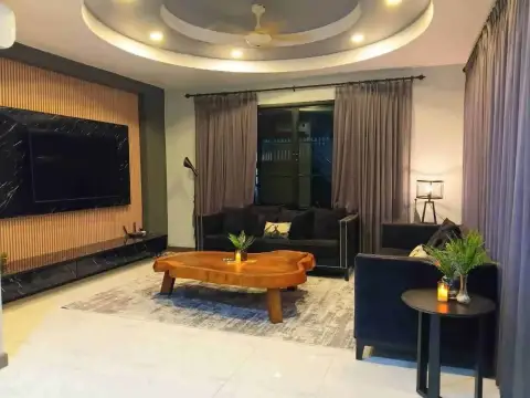 5 Bedroom House for Rent at Suksabai Villa living room with round ceiling design, flat screen TV, and sofas