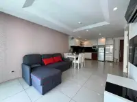 1 Bedroom Condo for Sale at Sunset Boulevard Residence 1 open-plan living room with sofa and kitchen area