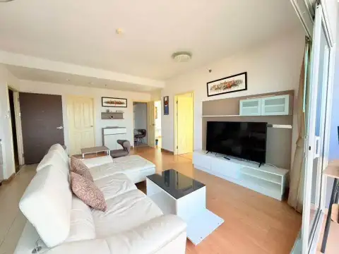 2 Bedroom Condo for Rent at Supalai Mare Pattaya open living area with leather sofa and wood flooring