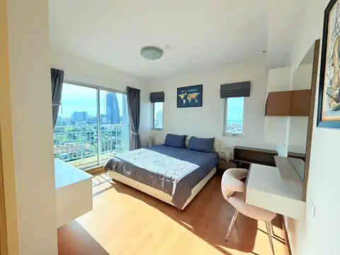 2 Bedroom Condo for Rent at Supalai Mare Pattaya bedroom with king bed, balcony access, and city skyline view