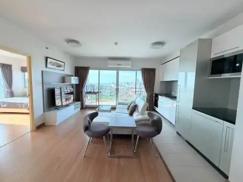 2 Bedroom Condo for Rent at Supalai Mare Pattaya open-plan kitchen with white cabinetry and living area view