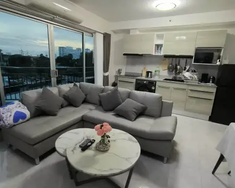 2 Bedroom Condo for Rent at Supalai Mare Pattaya open-plan lounge and kitchenette with balcony view